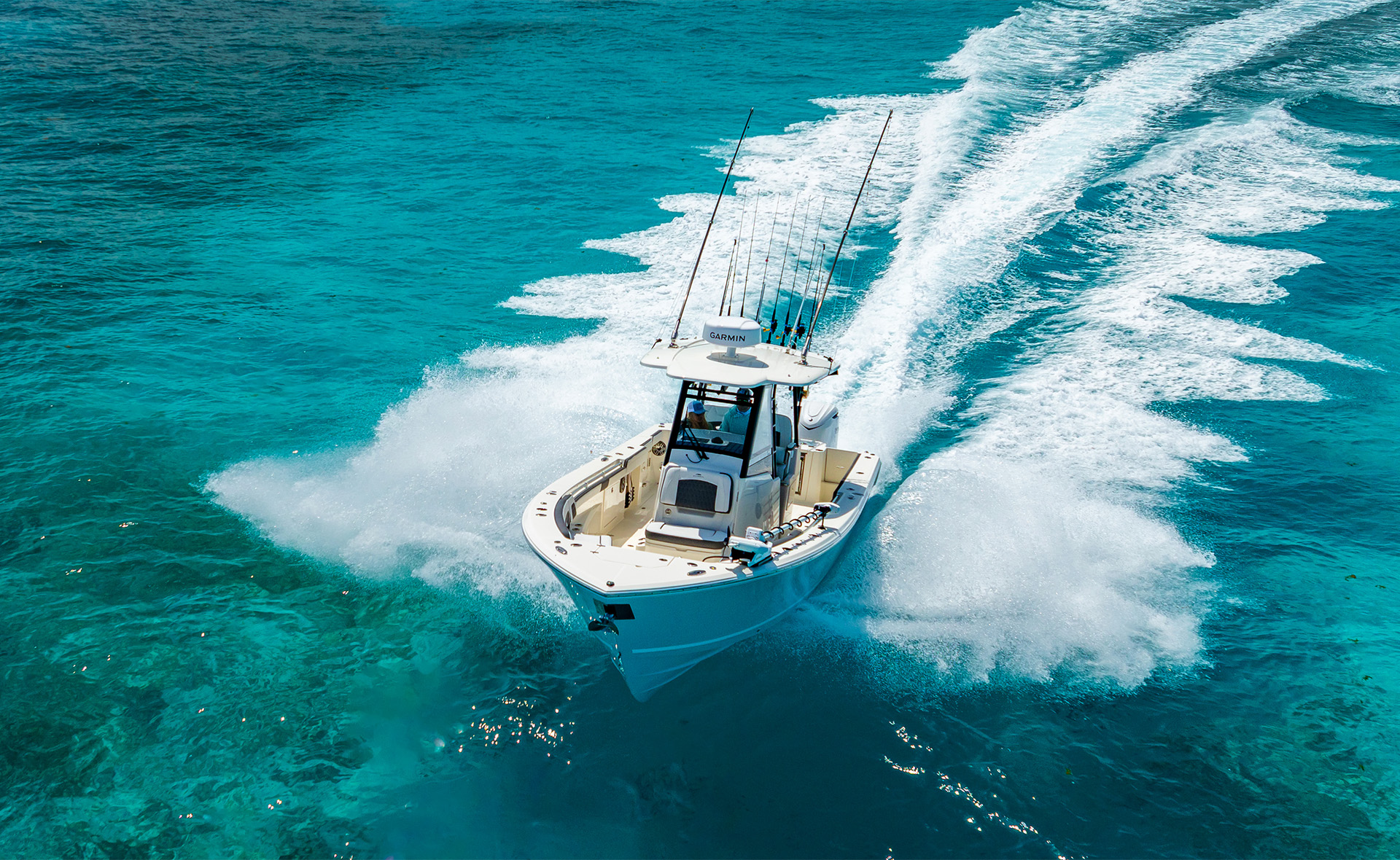 a boat going fast one clear blue water