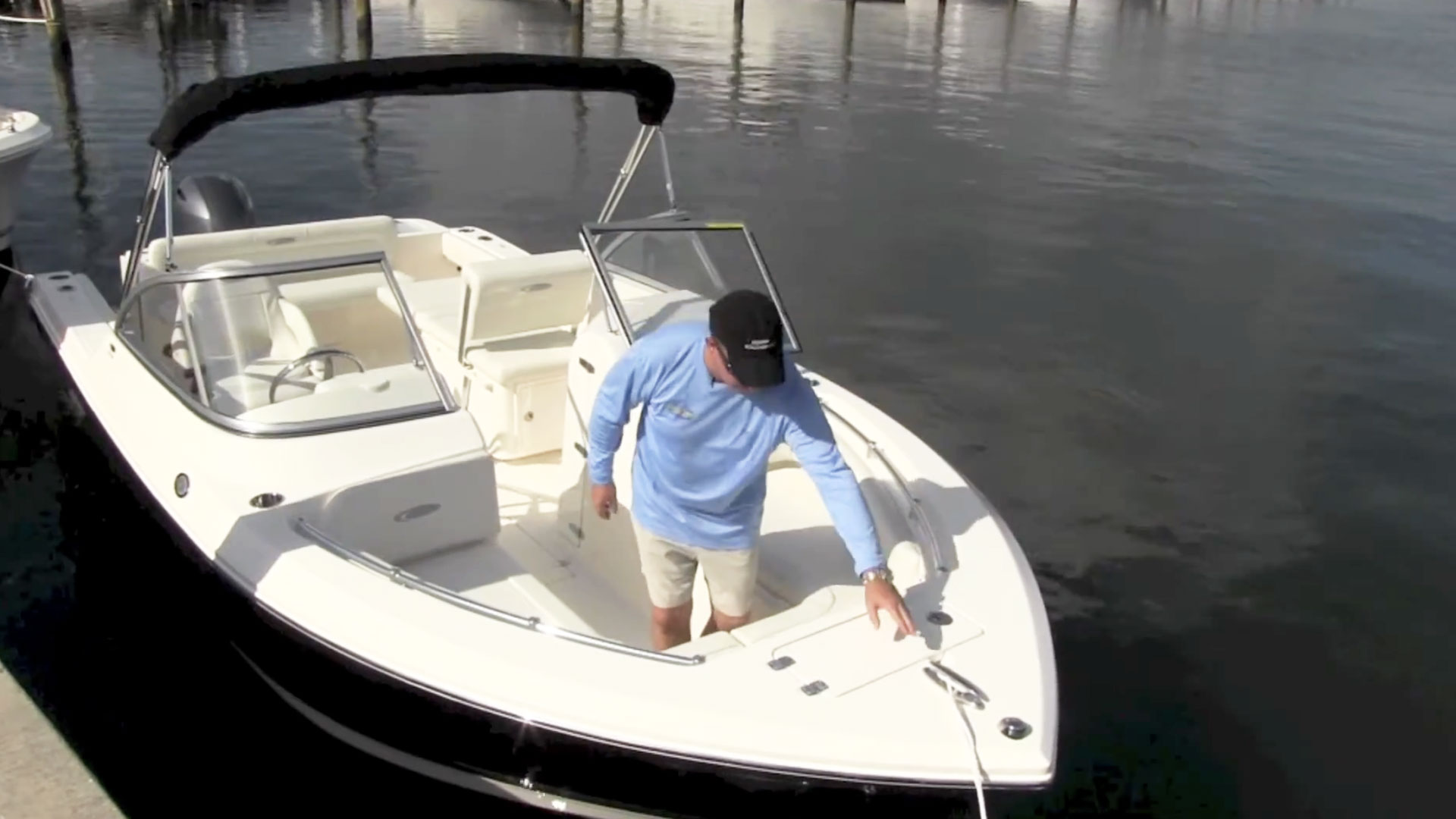 man giving walkthrough of 220 dc boat