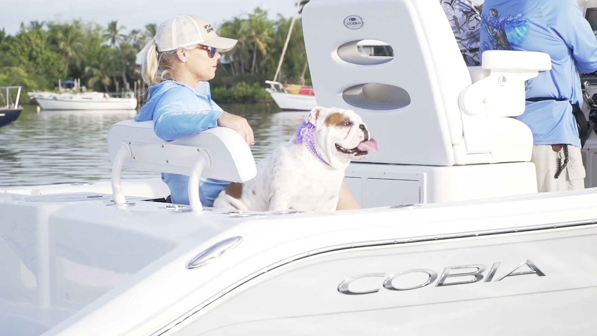 woman and dog in back of boat